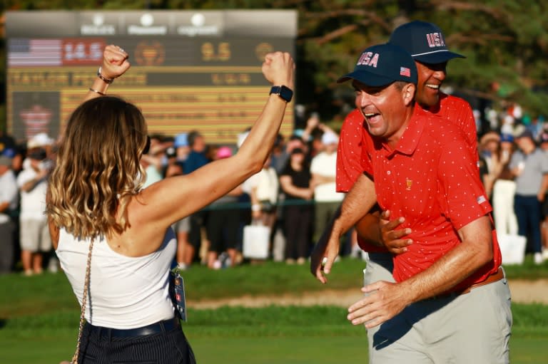 Keegan Bradley, right, celebrates with wife Jillian, left, after taking a trophy-clinching 1-up victory at the Presidents Cup (Vaughn Ridley)