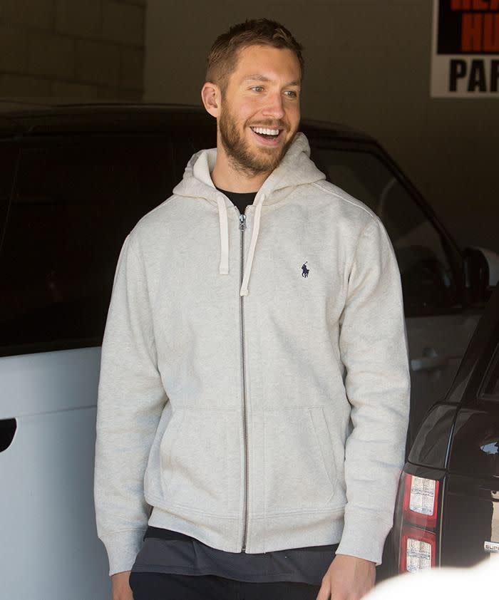 All smiles. Calvin trying to hide heartbreak the day after Taylor and Tom were caught kissing. Photo: Splash