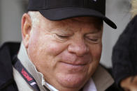 Team owner Chip Ganassi looks at his phone in his pit stall during a practice session for the Rolex 24 hour auto race at Daytona International Speedway, Friday, Jan. 28, 2022, in Daytona Beach, Fla. (AP Photo/John Raoux)