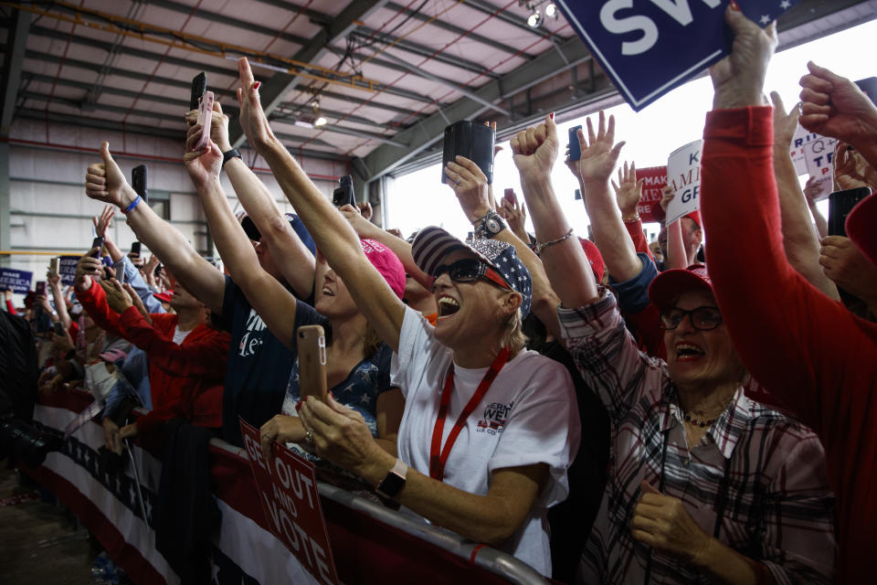 Supporters of President Donald Trump cheer as he arrives to speak at a campaign rally, Sunday, Nov. 4, 2018, in Macon, Ga. (AP Photo/Evan Vucci)