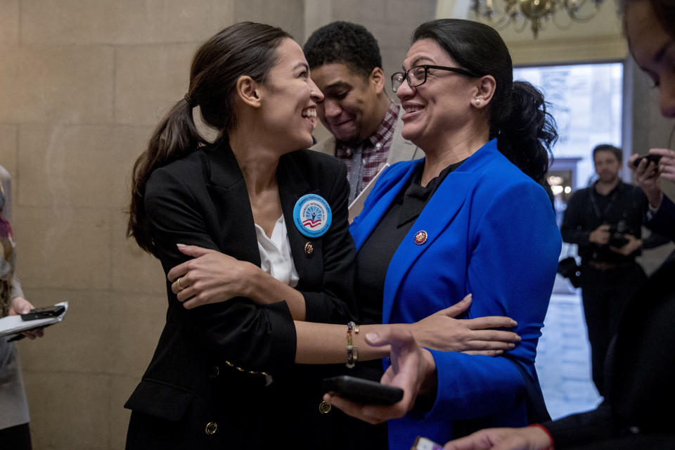 In this Jan. 16, 2019, photo, Rep. Alexandria Ocasio-Cortez, D-N.Y., left, and Rep. Rashida Tlaib, D-Mich., right, laugh as they wait for other freshman Congressmen to deliver a letter calling to an end to the government shutdown to deliver to the office of Senate Majority Leader Mitch McConnell of Ky., on Capitol Hill in Washington. It's known as "the theater committee" for its high profile, high-drama role investigating President Donald Trump's White House. And now, five of the fieriest Democratic freshmen in the House are players on that stage. (AP Photo/Andrew Harnik)
