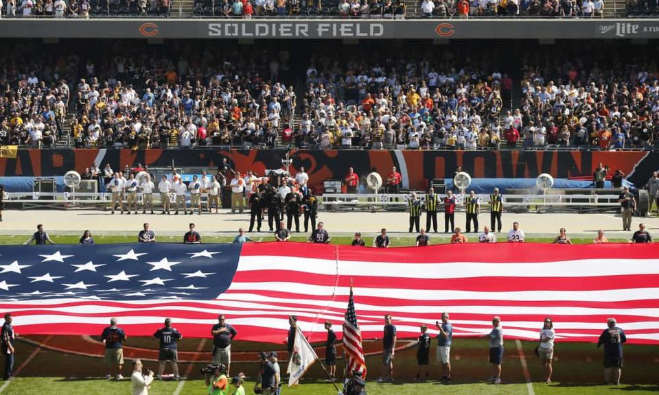 The Pittsburgh Steelers sideline is nearly empty during the playing of the national anthem at Soldier Field. Photograph: Kiichiro Sato/AP