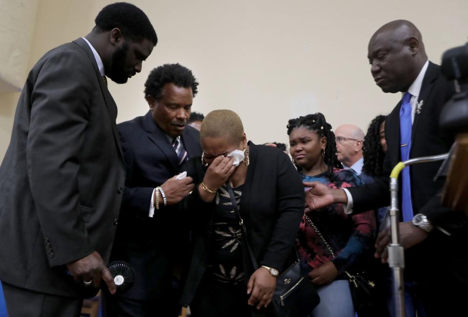 Tiffany Whitfield, center, the daughter of Ruth Whitfield, is consoled by her brother Garnell Whitfield Jr., left, and other family members at a news conference in Buffalo, N.Y.