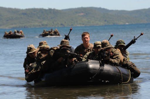 US and Filipino soldiers are seen on a boat during a joint mock beachfront assault on the shore of Ulugan Bay on Palawan island in April 2012. The Philippines says it has secured a pledge from its key military ally, the United States, that it would protect it from attacks in the South China Sea