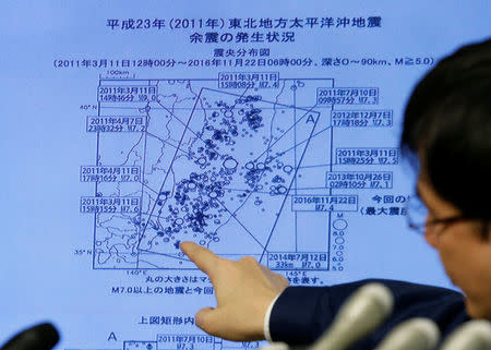 Japan Meteorological Agency's earthquake and volcano observations division director Koji Nakamura points at a map showing earthquake information during a news conference in Tokyo, Japan November 22, 2016. REUTERS/Toru Hanai