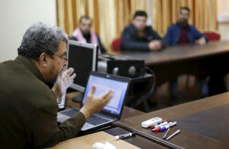 Psychiatrist Jamil Tahrawi (L), gives marriage counseling class to Palestinian grooms, at the Islamic University in Gaza City January 19, 2016. Picture taken January 19, 2016. REUTERS/Suhaib Salem