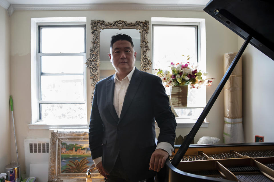 Charlton Rhee poses for a photo in the Queens borough of New York, Aug. 18, 2020. Rhee, whose parents came to the U.S. from South Korea, lost both of them to COVID-19 this spring as the virus surged in New York City. A joint analysis by The Associated Press and The Marshall Project found that Asian Americans join Black and Hispanic Americans among the hardest-hit groups, with deaths in each group up at least 30% this year. (AP Photo/Marshall Ritzel)