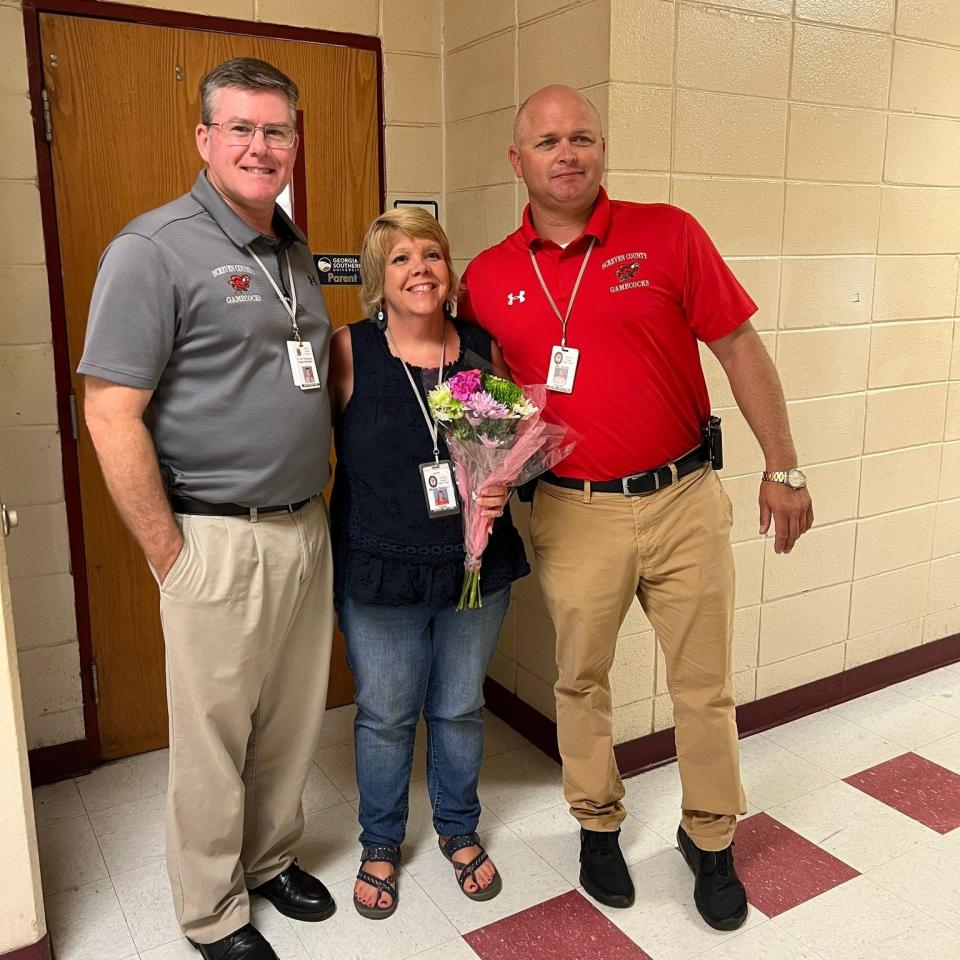 Screven County High School teacher Mindy Skinner, center was honored as the school's 2022-2023 Teacher of the Year by Superintendent Jim Thompson, left, and Principal Brian Scott.