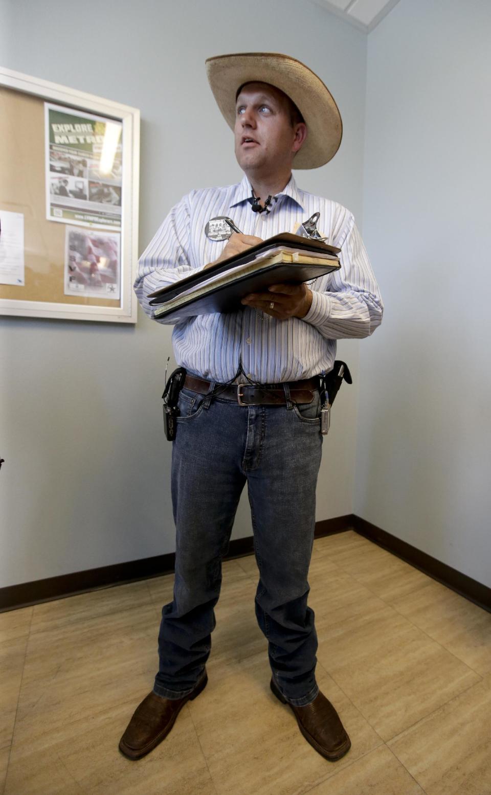 Ammon Bundy, son of rancher Cliven Bundy fills out a criminal complaint he is going to file against the Bureau of Land Management at Metropolitan Police Department headquarters, Friday, May 2, 2014 in Las Vegas. Last month, federal agents launched a cattle roundup on the Bundy ranch after they refused a court order to remove their cattle from public land and pay a grazing fee.(AP Photo/Chris Carlson)