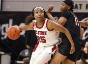 North Carolina State's Kayla Jones (25) drives around Virginia Tech's D'asia Gregg (11) during the first half of an NCAA college basketball game, Sunday, Jan. 24, 2021 in Raleigh, N.C. (Ethan Hyman/The News & Observer via AP)