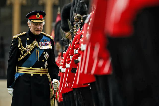 <p>Ben Stansall - WPA Pool/Getty </p> King Charles presents new colours to the Irish Guards at Windsor Castle on June 10, 2024.