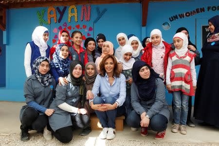 Syrian refugee girls take a photo with Noura Jumblatt, founder of the NGO Kayany Foundation, at a school for Syrian refugee girls, built by the foundation in Bar Elias town, in the Bekaa valley, Lebanon October 19, 2017. Picture taken October 19, 2017. REUTERS/Aziz Taher