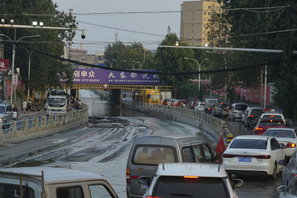 Vehicles, some ferrying supplies, arrive in Xinxiang in central China's Henan province on Sunday, July 25, 2021. Trucks carrying water and food on Sunday streamed into the Chinese city at the center of flooding that killed dozens of people, while soldiers laid sandbags to fill gaps in river dikes that left neighborhoods under water. (AP Photo/Dake Kang)