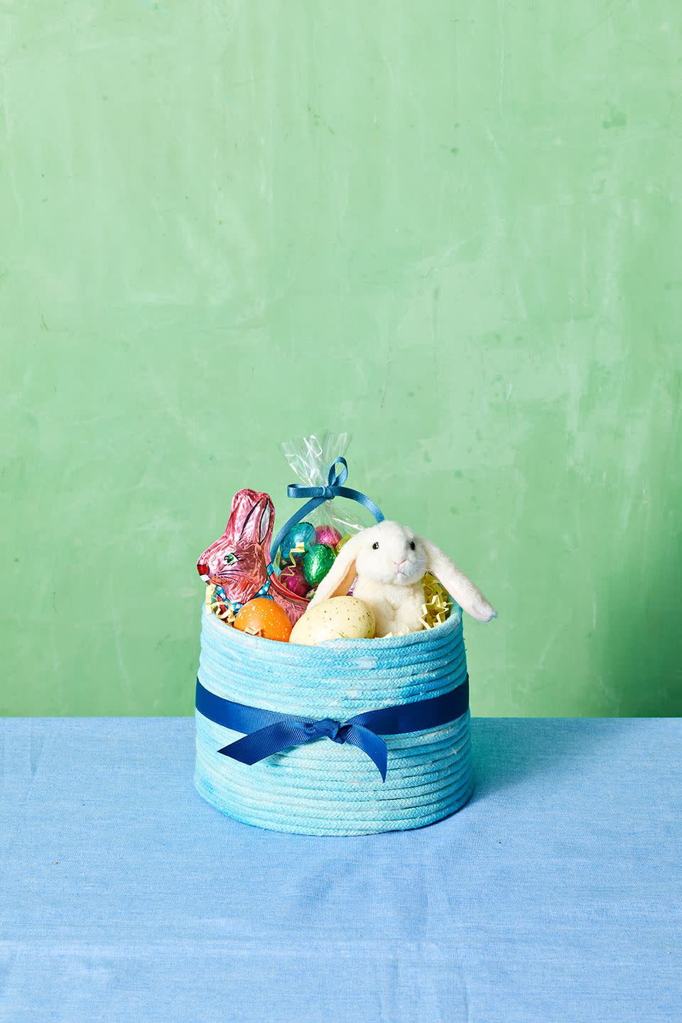 easter basket ideas, blue basket decorated with blue rope and a blue ribbon