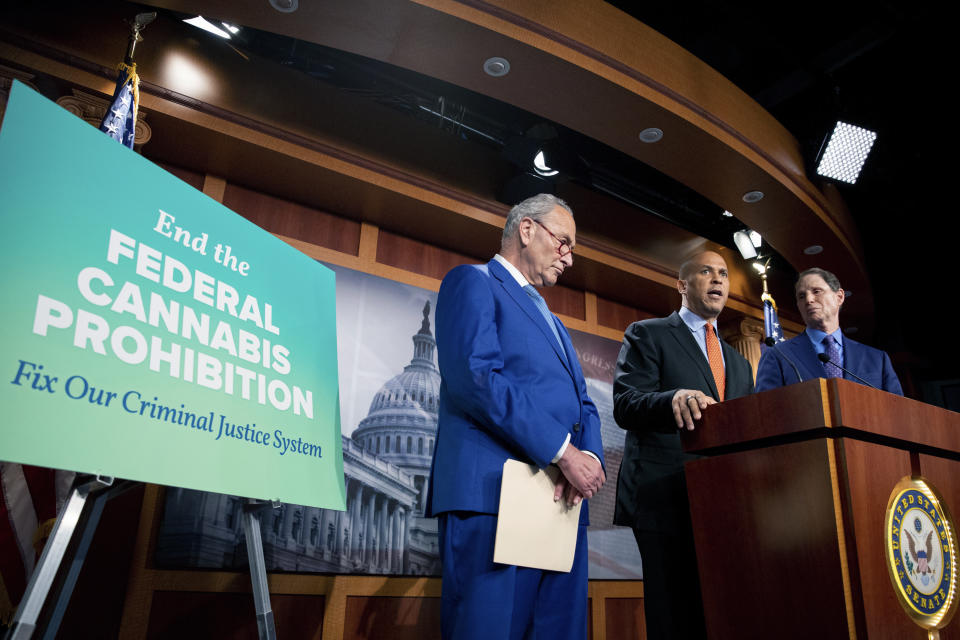 FILE - From left, Senate Majority Leader Chuck Schumer, D-N.Y., Sen. Cory Booker, D-N.J., and Sen. Ron Wyden, D-Ore., announce a draft bill that would decriminalize marijuana on a federal level Capitol Hill in Washington, Wednesday, July 14, 2021. The bill, called the Cannabis Administration and Opportunity Act, would not only decriminalize marijuana, but also expunge the records of those with non-violent convictions related to cannabis and invest money into restorative justice programs. (AP Photo/Amanda Andrade-Rhoades, File)