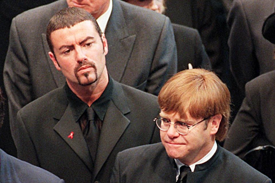 Pop stars George Michael (top) and Elton John leave Westminster Abbey after the funeral service 06 September of Diana Princess of Wales. The Princess was killed in a car crash in Paris 31 August. (Photo credit should read JOHNNY EGGITT/AFP via Getty Images)