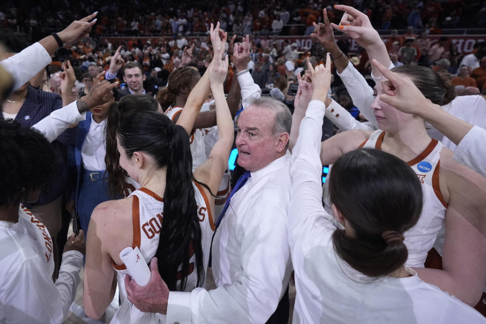Texas head coach Vic Schaefer, center, celebrates with his team after their win over Alabama in a second-round college basketball game in the women’s NCAA Tournament in Austin, Texas, Sunday, March 24, 2024. (AP Photo/Eric Gay)
