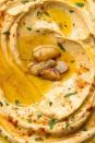 <p>Hummus is a Middle Eastern dish made of chickpeas and tahini. Garlic or roasted red peppers and other spices are common additions. It's good on <a href="https://www.delish.com/uk/cooking/recipes/a30178392/best-chicken-shawarma-recipe/" rel="nofollow noopener" target="_blank" data-ylk="slk:Chicken Shawarma;elm:context_link;itc:0;sec:content-canvas" class="link ">Chicken Shawarma</a> or <a href="https://www.delish.com/uk/cooking/recipes/a29082528/easy-homemade-falafel-recipe/" rel="nofollow noopener" target="_blank" data-ylk="slk:Falafel;elm:context_link;itc:0;sec:content-canvas" class="link ">Falafel</a>.</p><p>Get the <a href="https://www.delish.com/uk/cooking/recipes/a34092710/best-homemade-hummus-recipe/" rel="nofollow noopener" target="_blank" data-ylk="slk:Classic Homemade Hummus;elm:context_link;itc:0;sec:content-canvas" class="link ">Classic Homemade Hummus</a> recipe.</p>