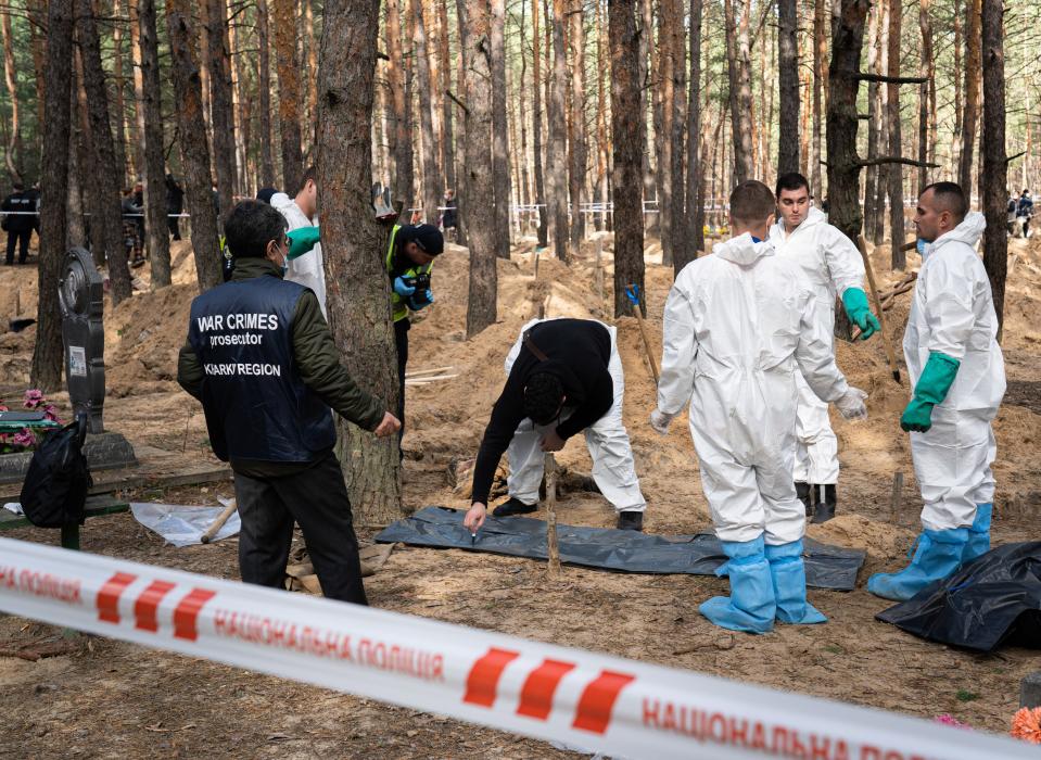 Investigators, including workers from the "war crime prosecutors, Kharkiv region", are seen at the mass burial site. A mass burial site was found on the outskirt of the eastern Ukrainian city, Izium, Kharkiv region, which was liberated from Russian occupation two weeks ago. At least 445 new graves were found on the site of an existing cemetery, while many only have numbers written on the wooden cross. All bodies will be exhumed and sent for forensic examination, but it was told from initial investigations that some bodies showed signs of torture.