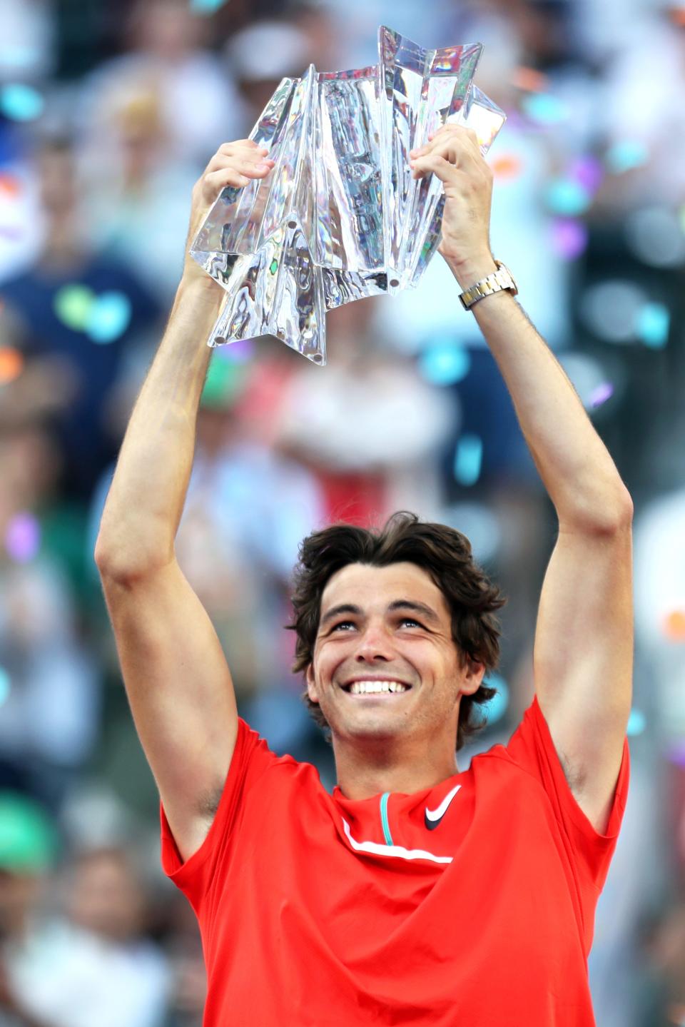 American Taylor Fritz lifts the BNP Paribas Open trophy after defeating Rafael Nadal of Spain at the Indian Wells Tennis Garden in Indian Wells, Calif., on Sunday, March 2022. 