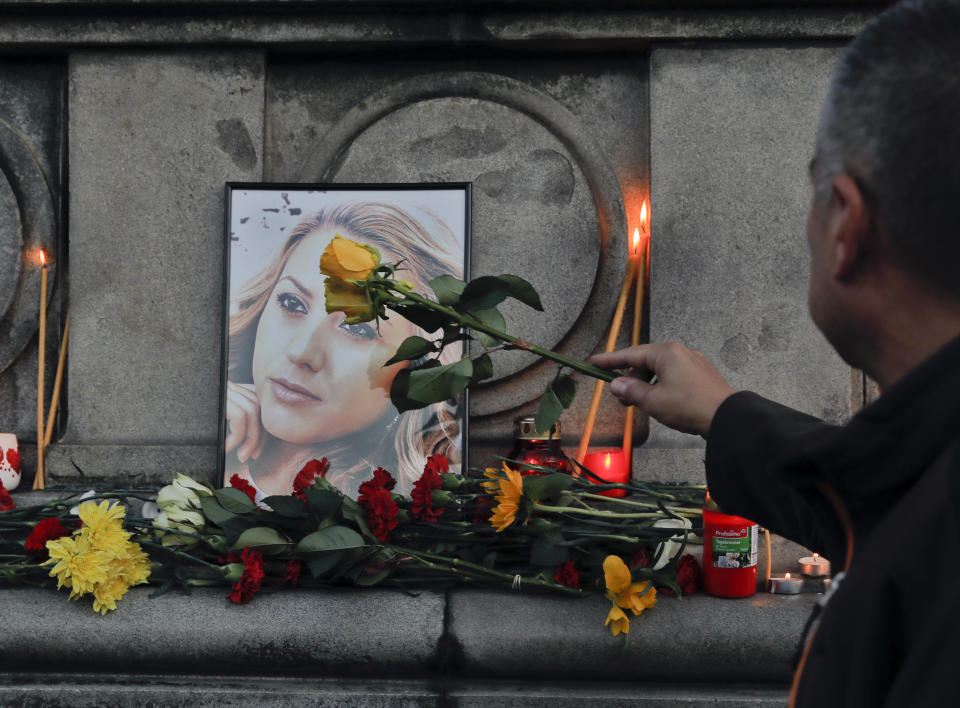 A portrait of the Bulgarian journalist Viktoria Marinova, killed in the northern town of Ruse, is seen during a vigil in Sofia, Monday, Oct. 8, 2018. Bulgarian police are investigating the rape, beating and slaying of a female television reporter whose body was dumped near the Danube River after she reported on the possible misuse of European Union funds in Bulgaria. (AP Photo/Valentina Petrova)