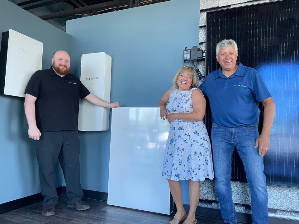 The Green Panel employees, from left, Blake Alexander, Denise Bretsik and Eric Roberts stand near renewable energy products in their new Brighton showroom on Thursday, July 14, 2022.