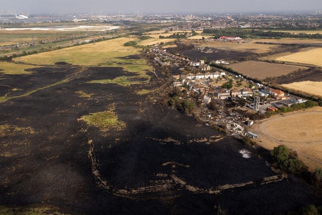 Aerial view of burned fields and properties after a blaze in the village of Wennington, east London 