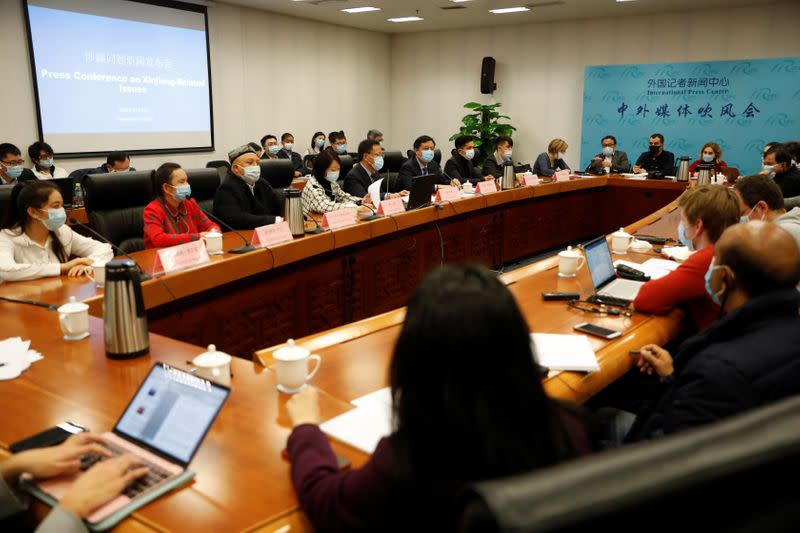 Xu Guixiang, deputy head of Xinjiang's publicity department attends a news conference in Beijing