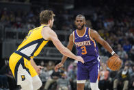 Phoenix Suns' Chris Paul (3) is defended by Indiana Pacers' Domantas Sabonis (11) during the second half of an NBA basketball game, Friday, Jan. 14, 2022, in Indianapolis. (AP Photo/Darron Cummings)