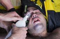 <p>A White Supremacist has a special mixture poured in his eyes after being hit with pepper spray during clashes with counter protestors at Emancipation Park where the White Nationalists are protesting the removal of the Robert E. Lee monument in Charlottesville, Va., on Aug. 12, 2017. (Photo: Samuel Corum/Anadolu Agency/Getty Images) </p>