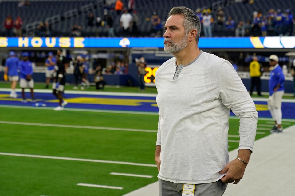 Former quarterback Kurt Warner watches players warm up before an NFL wild-card playoff football game between the Los Angeles Rams and the Arizona Cardinals in Inglewood, Calif., Monday, Jan. 17, 2022.