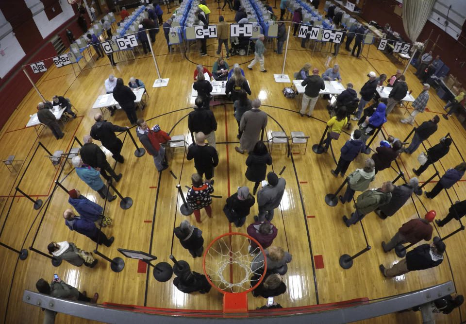 Voters wait in line in the gymnasium at Brunswick Junior High School to receive their ballots for the midterm election in Brunswick, Maine.