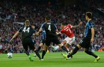 Manchester United's Memphis Depay (2nd R) scores his team's first goal during the UEFA Champions League play off against Club Brugge at Old Trafford on August 18, 2015