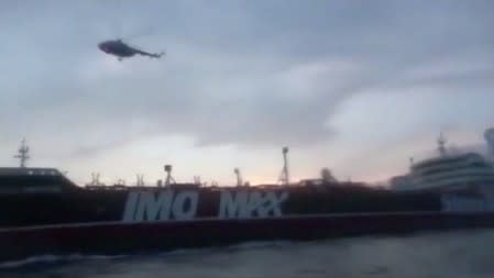 A helicopter hovers over British-flagged tanker Stena Impero near the strait of Hormuz