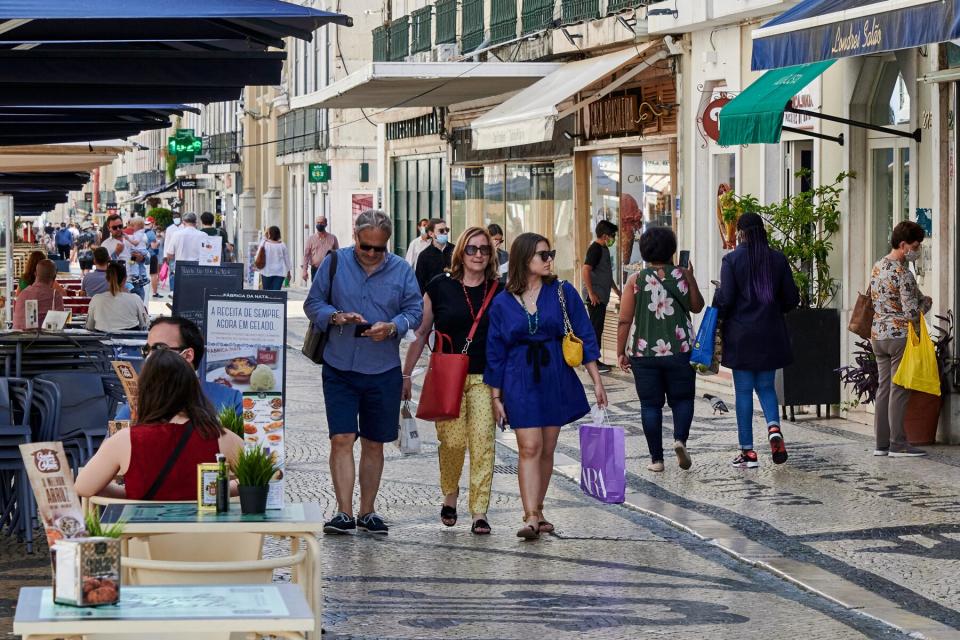 People are seen walking in Rua Augusta, Lisbon, Portugal