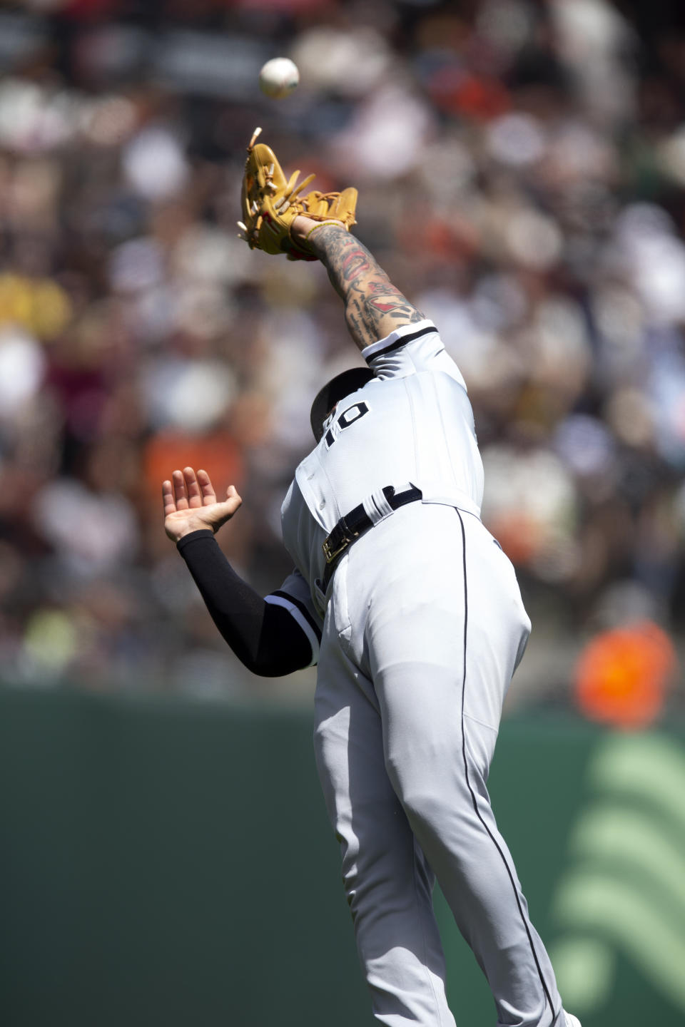 Chicago White Sox third baseman Yoán Moncada jumps to catch a popup by San Francisco Giants' Brandon Belt during the fourth inning of a baseball game, Sunday, July 3, 2022, in San Francisco. (AP Photo/D. Ross Cameron)