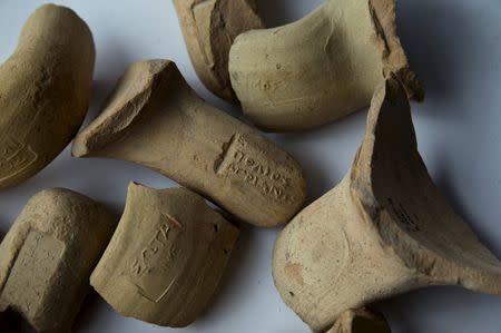 Wine jug handles, uncovered by Israeli archaeologists at a site that they say contains the remnants of an ancient Greek fortress, are displayed in Jerusalem November 3, 2015. REUTERS/Ronen Zvulun