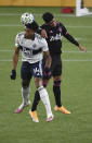 Vancouver Whitecaps forward Theo Bair, left, and Seattle Sounders defender Xavier Arreaga fo up for a head ball during the first half of an MLS soccer match in Portland, Ore., Tuesday, Oct. 27, 2020. (AP Photo/Steve Dykes)