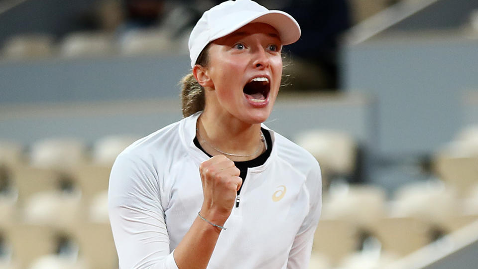 Iga Swiatek is pictured celebrating after defeating Simona Halep at the French Open 2020.