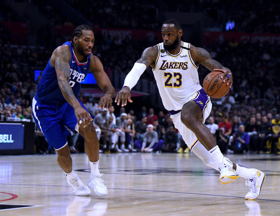 LOS ANGELES, CALIFORNIA - MARCH 08:  LeBron James #23 of the Los Angeles Lakers drives to the basket on Kawhi Leonard #2 of the LA Clippers during a 112-103 Lakers win at Staples Center on March 08, 2020 in Los Angeles, California.   NOTE TO USER: User expressly acknowledges and agrees that, by downloading and or using this photograph, User is consenting to the terms and conditions of the Getty Images License Agreement.  (Photo by Harry How/Getty Images)