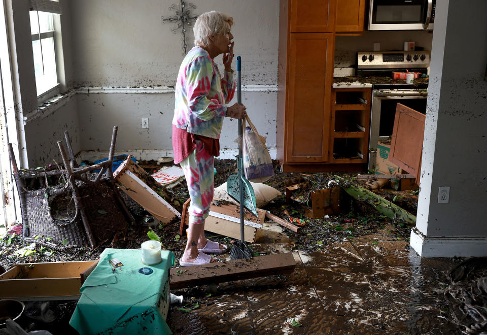 <p>Fort Myers, Florida, resident Stedi Scuderi looks over her flooded apartment on Sept. 29.</p>