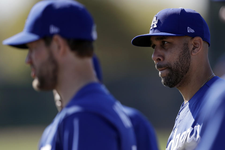 Los Angeles Dodgers pitcher David Price, right, stands with pitcher Clayton Kershaw, left, during spring training baseball Friday, Feb. 14, 2020, in Phoenix. (AP Photo/Gregory Bull)