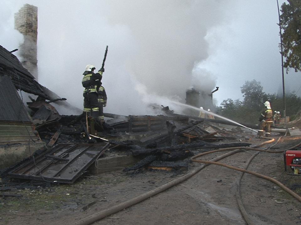 Firefighters work near a psychiatric hospital destroyed by fire in the Novgorod region town of Luka in this September 13, 2013 picture provided by the Russian Emergencies Ministry. The fire raged through the Russian psychiatric hospital on Friday, killing at least one person and leaving dozens missing as police searched the surrounding area for survivors, emergency and law enforcement officials said. Picture taken with a video camera. (REUTERS/Russian Emergencies Ministry of Novgorod region/Handout via Reuters)