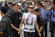 Police detain a supporter (C) of the female punk band "Pussy Riot" members for taking part in an unsanctioned rally outside a court building in Moscow, August 17, 2012.