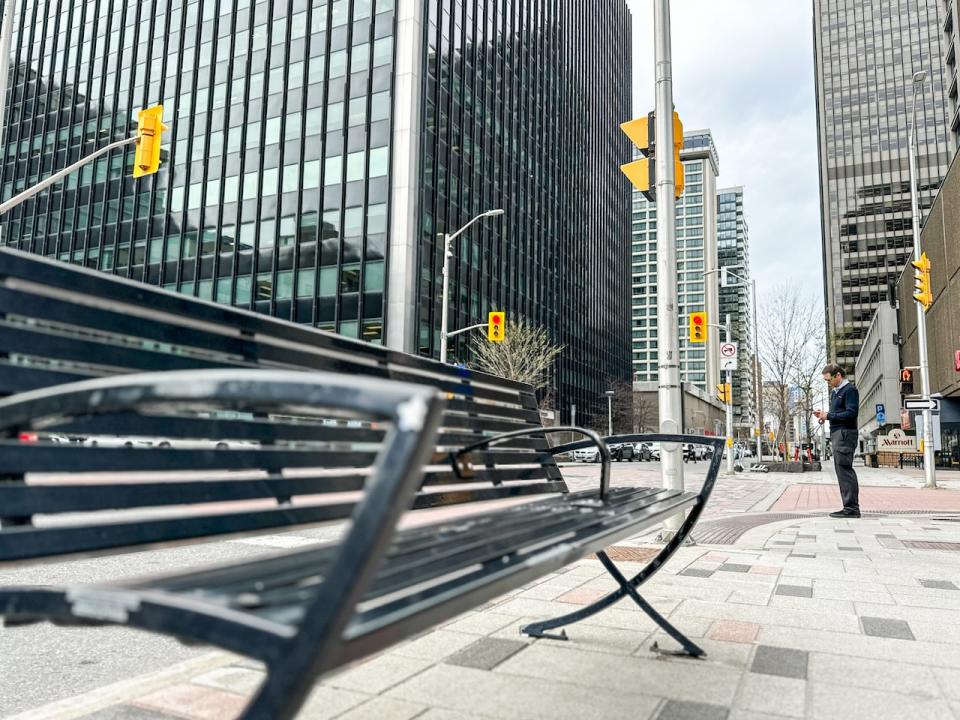 An empty bench sits on Queen Street in downtown Ottawa
