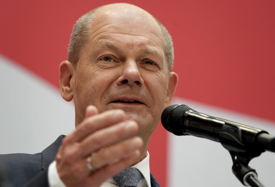 FILE - In this Monday, Sept. 27, 2021 file photo, Olaf Scholz, top candidate for chancellor of the Social Democratic Party (SPD), speaks during a press conference at the party's headquarters in Berlin. As Europe's economic powerhouse Germany embarks on the task of piecing together a new ruling coalition after the knife-edge election on Sunday Sept. 26, 2021, the country need only look to its neighbors, Belgium and the Netherlands, to see how tricky the process can be. (AP Photo/Michael Sohn, file)