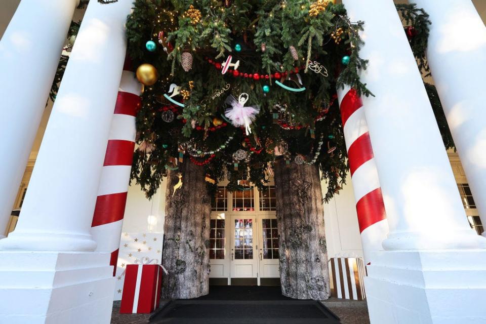 Christmas tree branches hanging outside the East Portico of the White House in 2023.