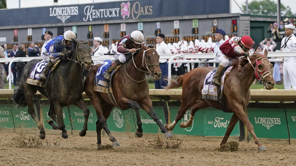 Rich Strike (21), with Sonny Leon aboard, leads Epicenter (3), with Joel Rosario aboard, and Zandon (10), with Flavien Prat aboard, down the straightaway to win the 148th running of the Kentucky Derby horse race at Churchill Downs Saturday, May 7, 2022, in Louisville, Ky. (AP Photo/Mark Humphrey)