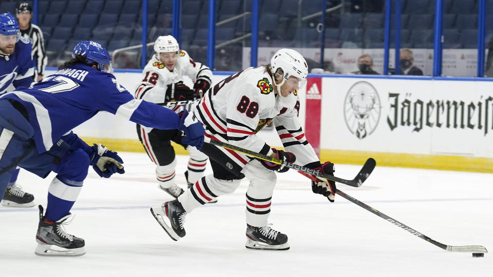 Chicago Blackhawks right wing Patrick Kane (88) breaks past Tampa Bay Lightning defenseman Ryan McDonagh (27) during the first period of an NHL hockey game Friday, Jan. 15, 2021, in Tampa, Fla. (AP Photo/Chris O'Meara)