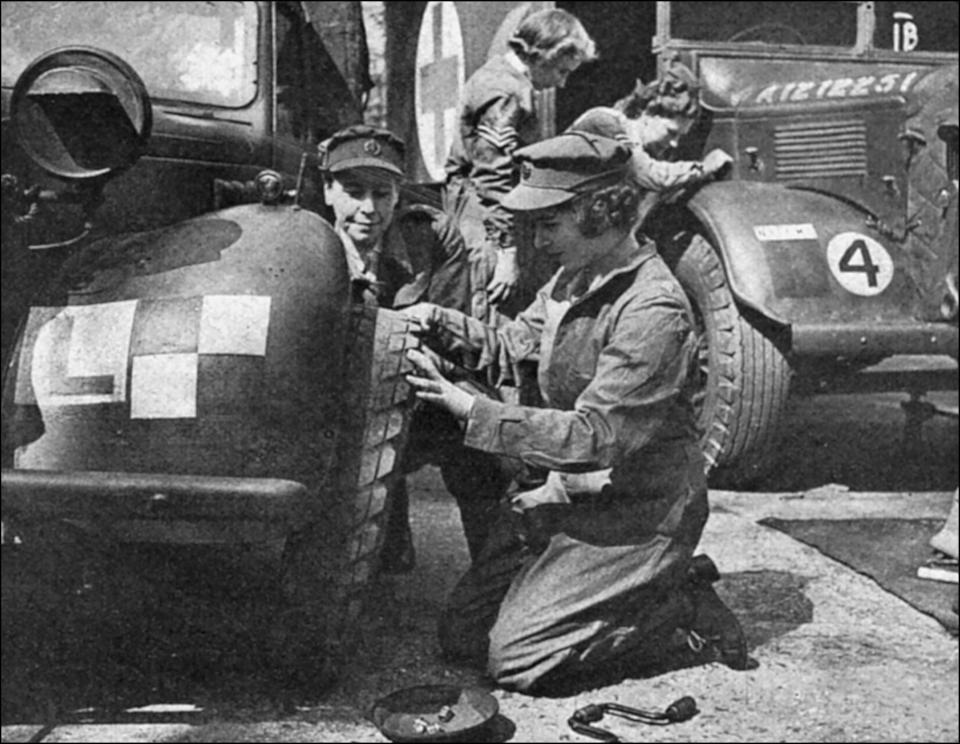 UNITED KINGDOM - CIRCA 1945:  Princess Elizabeth (born in 1926), future queen Elizabeth II of England, learning how to change a car wheel as an auxiliary-officer of the English Army, 1945.  (Photo by Roger Viollet via Getty Images)